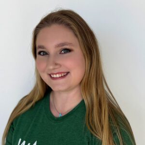 Mel wearing a green WAG shirt